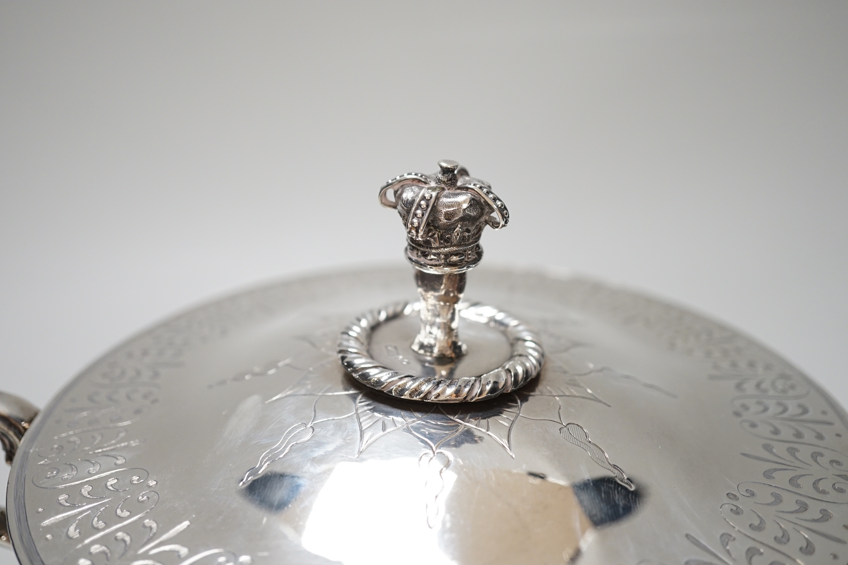 A Victorian silver tureen and cover, with hand holding crown finial and stylised anthemion engravings, makers initials W.T, London 1867, 23cm over handle, 673 grams